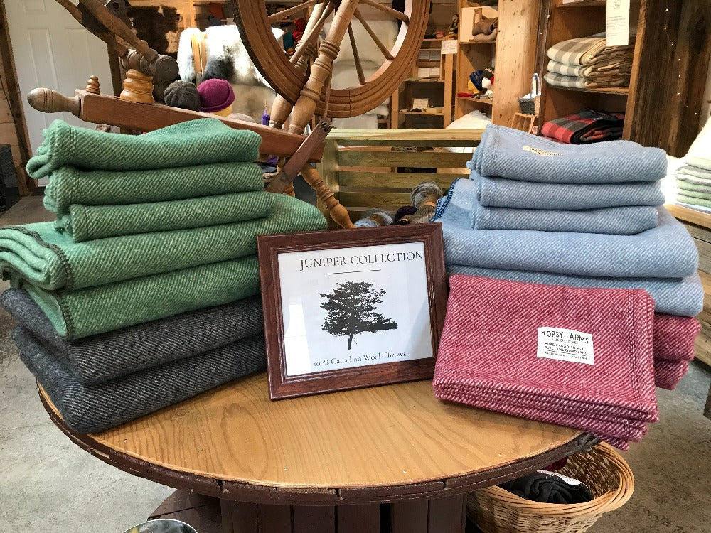 Topsy Farms' Canadian wool throws stacked on a table