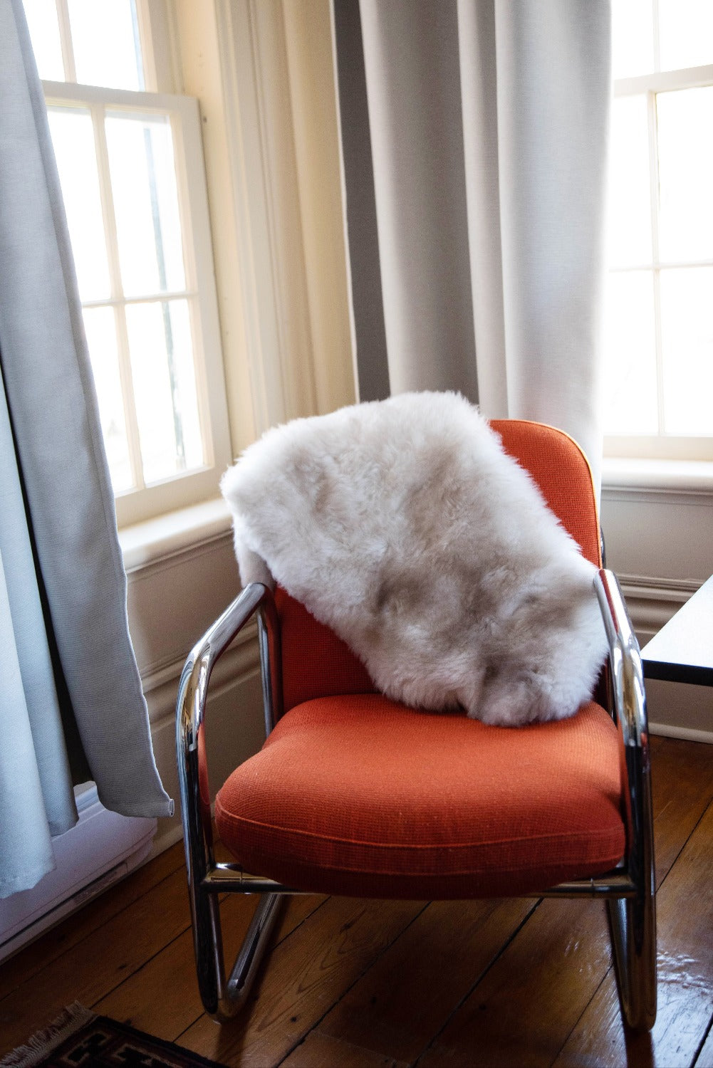 Topsy Farms' coloured lambskin on an orange chair