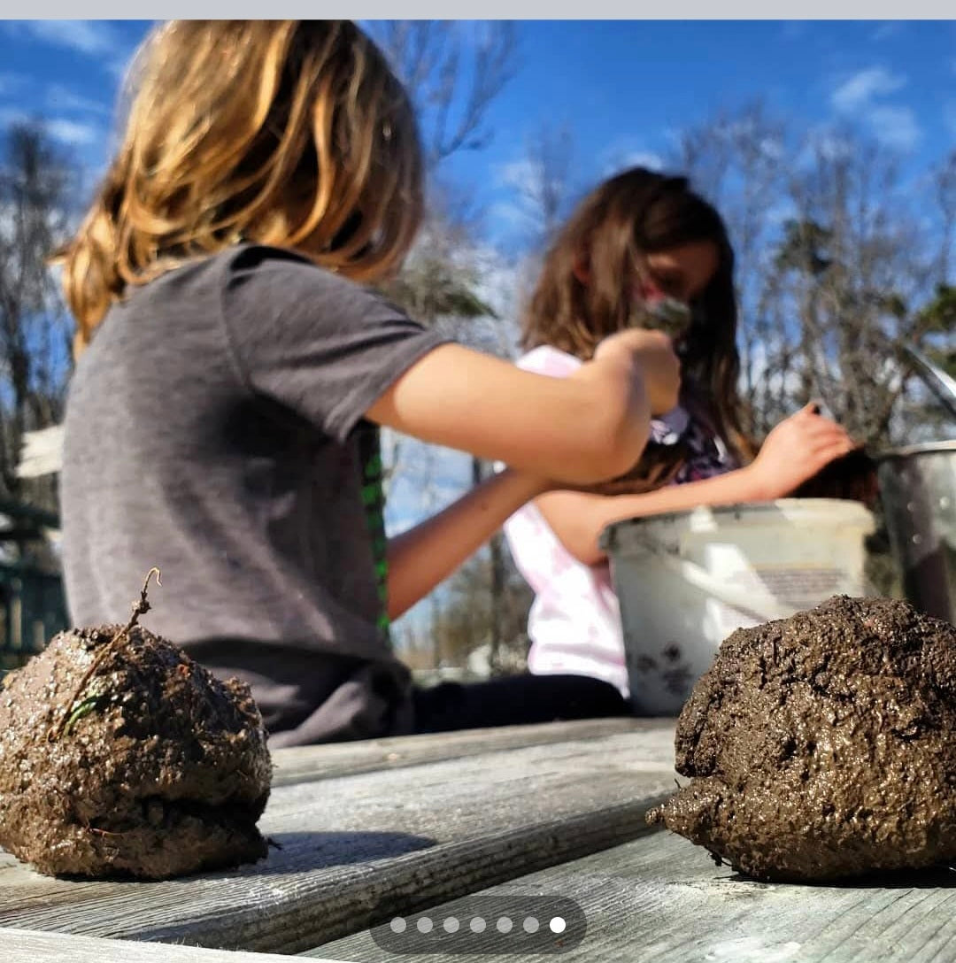 Two kids making seed bombs at Topsy Farms