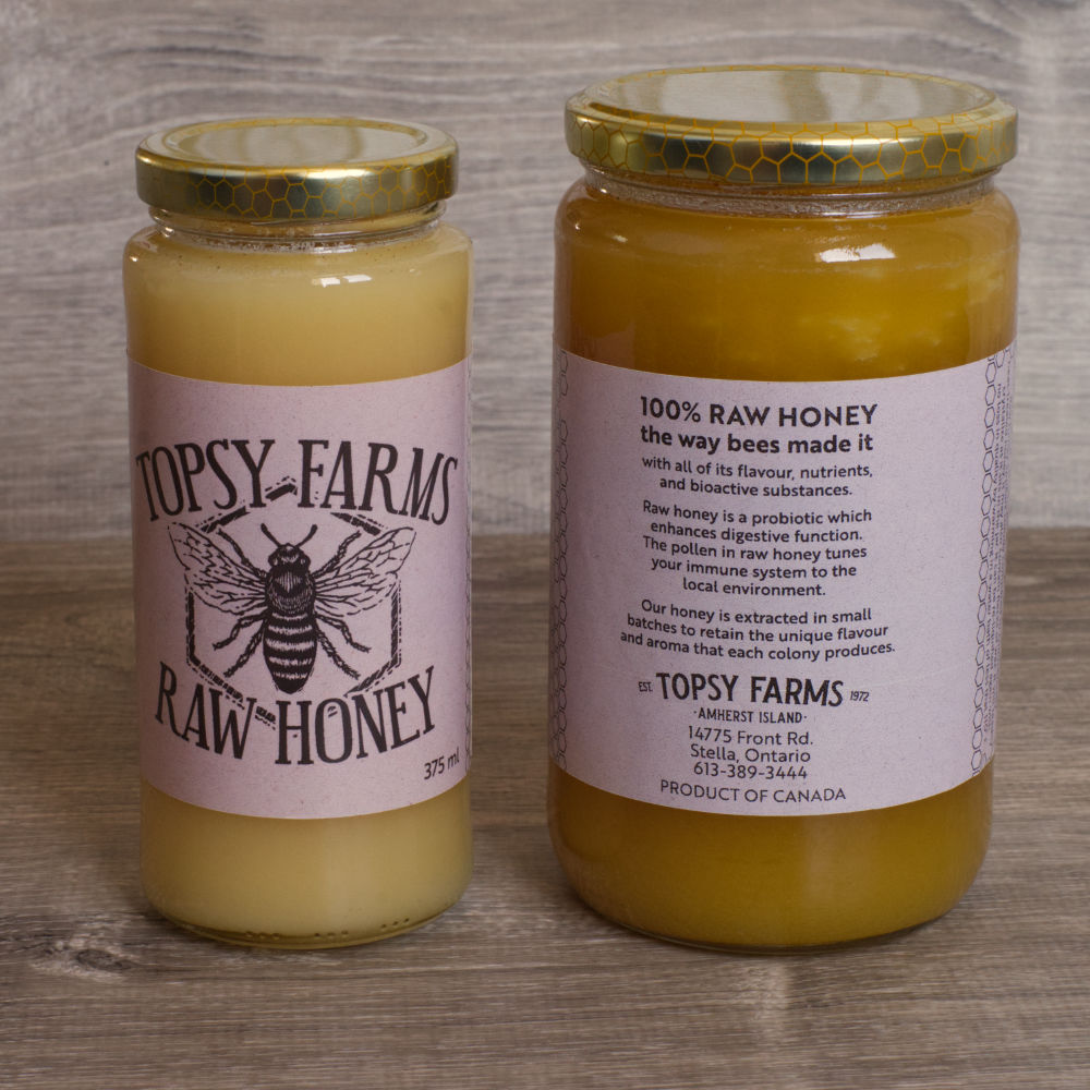 2 different sized jars of Topsy Farms Raw Honey with bee on label